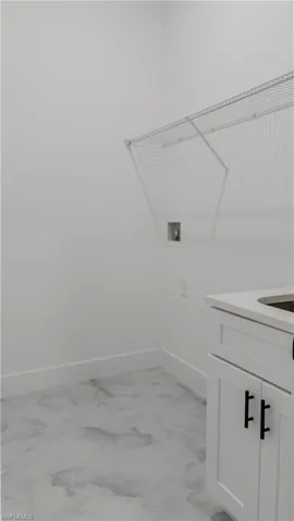 Laundry room featuring hookup for a washing machine and cabinet space