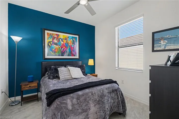 Bedroom with a ceiling fan and baseboards