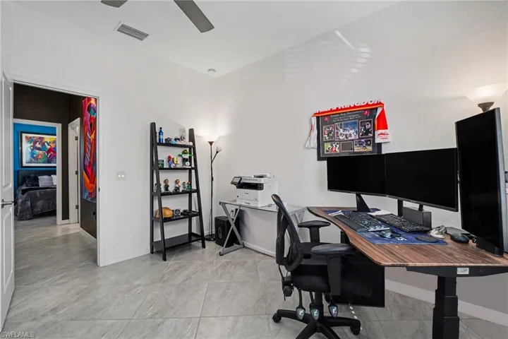 Office area with baseboards and a ceiling fan