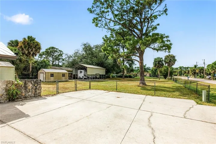 View of patio / terrace featuring a detached carport and concrete driveway