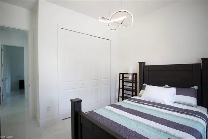 Tiled bedroom with a closet