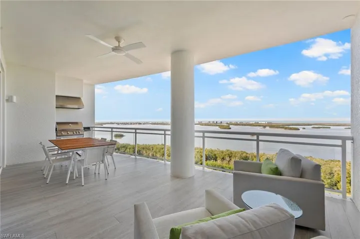 Open Lanai with preferred glass railings offering Bay and Gulf View.  Glass was a builder upgrade.