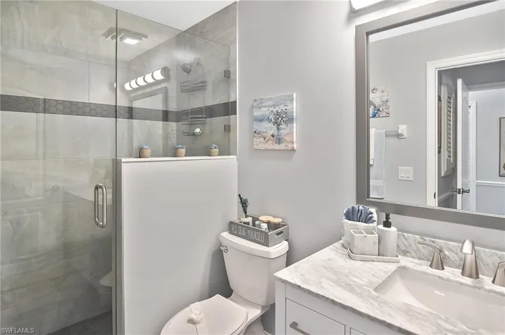 Full bathroom featuring vanity and a shower stall
