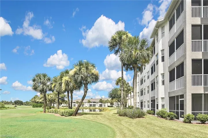 View of home's community with a water view, a lawn, and golf course view