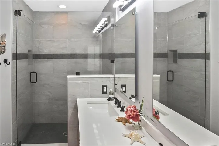 Bathroom with a shower stall and vanity