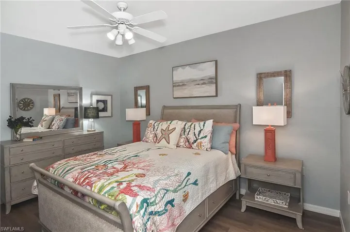 Bedroom with dark wood-style floors and ceiling fan