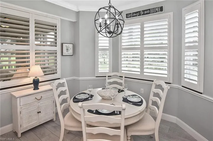 Dining space featuring a chandelier, ornamental molding, and light wood-type flooring