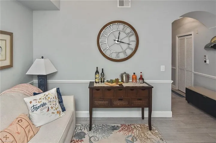 Sitting room featuring arched walkways and wood finished floors