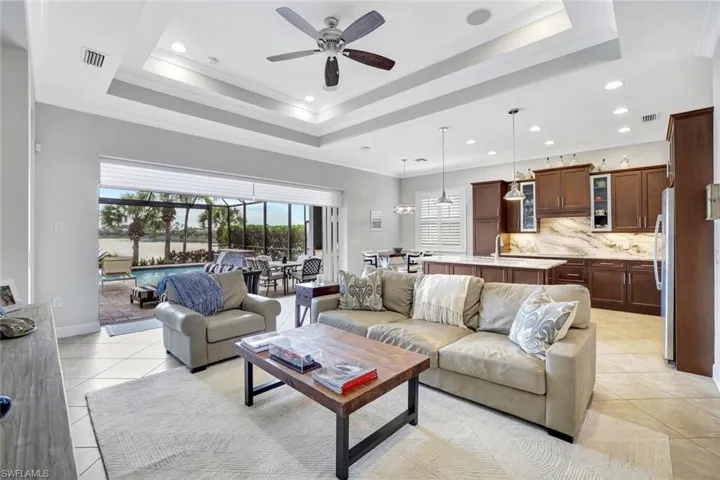 Living room with crown molding, ceiling fan, and recessed lighting