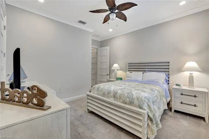 Bedroom featuring recessed lighting, crown molding, light colored carpet, and a ceiling fan