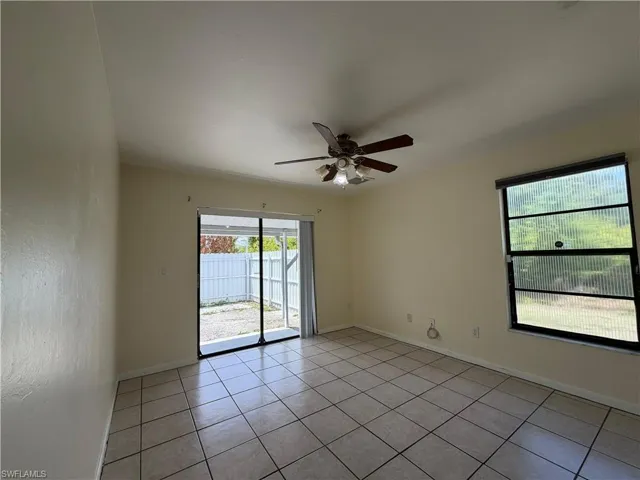 This room features tiled flooring, a ceiling fan with integrated lighting, and a window providing natural light