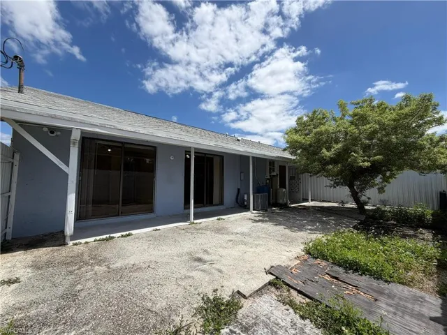 The property features a patio area with an overhead roof extension