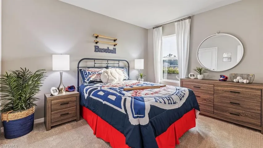 Model home. Bedroom with light carpet and baseboards