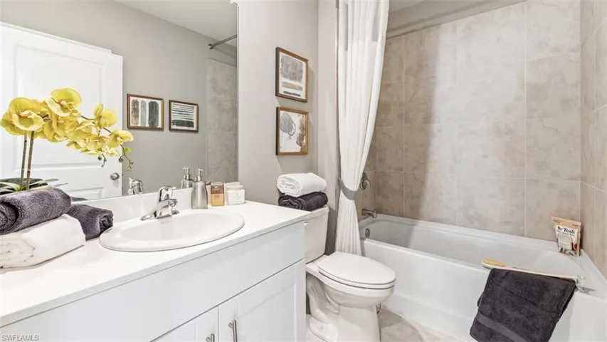 Model home. Full bathroom with vanity and shower / bath combo