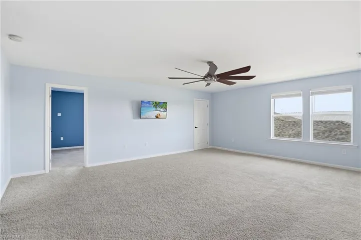 Unfurnished room with carpet flooring and ceiling fan