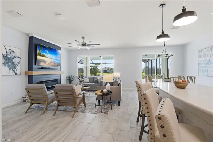 Living area featuring a fireplace and a ceiling fan