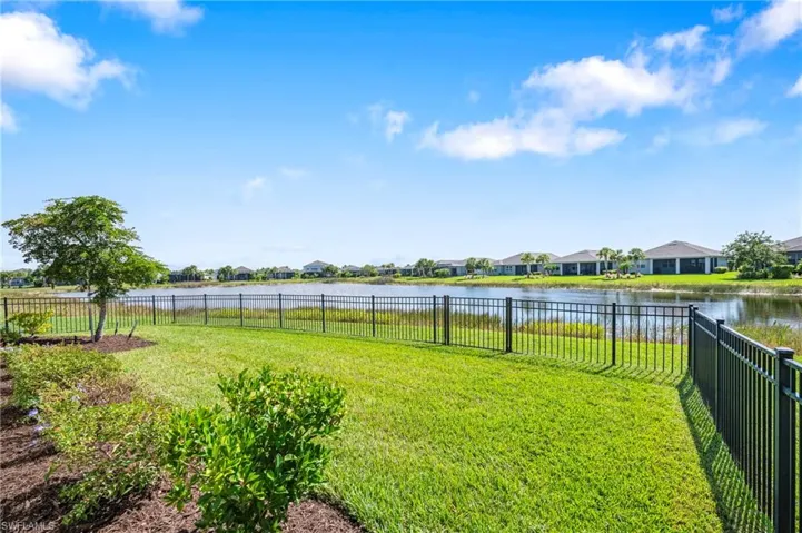 Fenced backyard with a water view