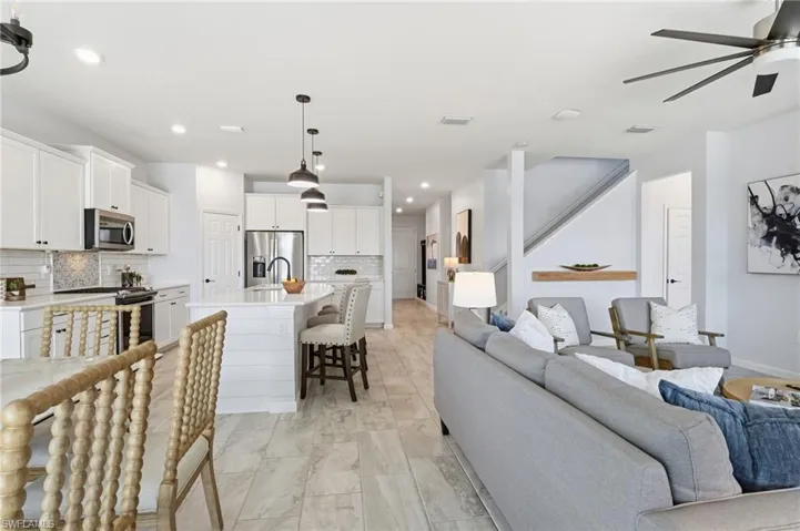 Living area featuring a ceiling fan and recessed lighting