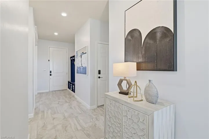 Corridor with recessed lighting and baseboards