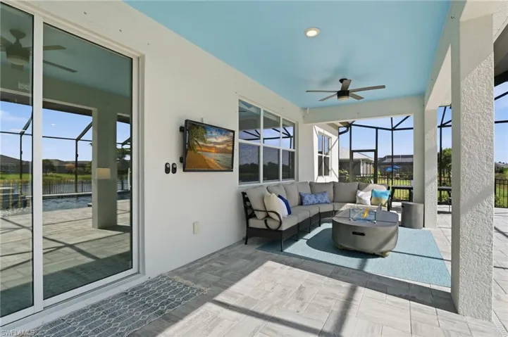 featuring ceiling fan, a patio, and an outdoor living space with a fire pit