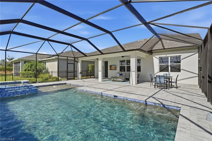 View of pool with connected hot tub, a patio, and ceiling fans