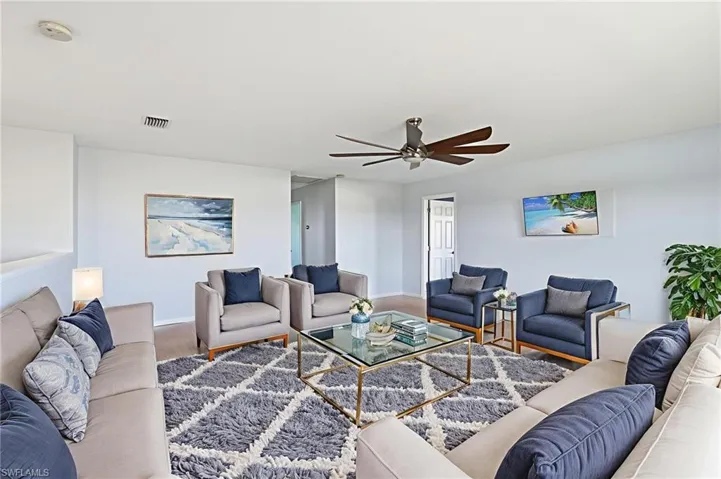 Living area with wood finished floors and a ceiling fan