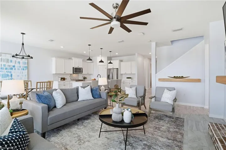 Living room with a chandelier and a ceiling fan