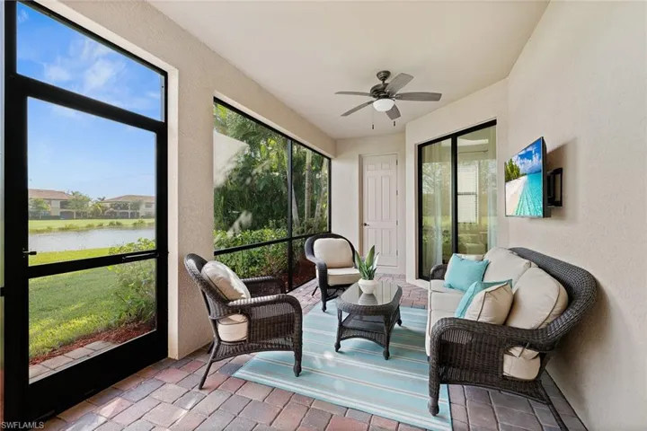 Sunroom with a water view and ceiling fan