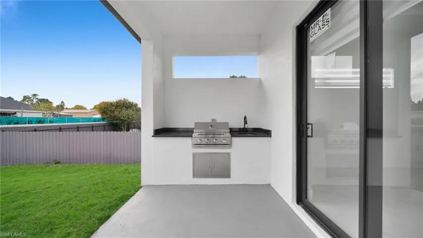 View of patio / terrace with an outdoor kitchen and a sink