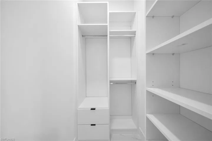 Walk in closet featuring marble look tile flooring