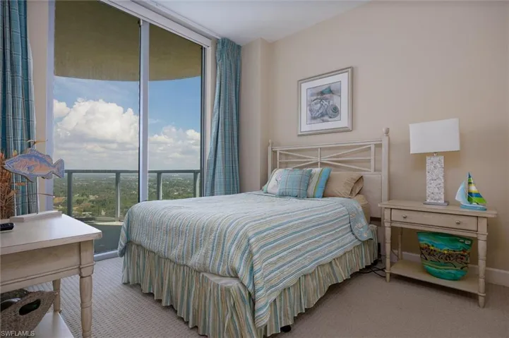 Bedroom featuring light colored carpet and baseboards