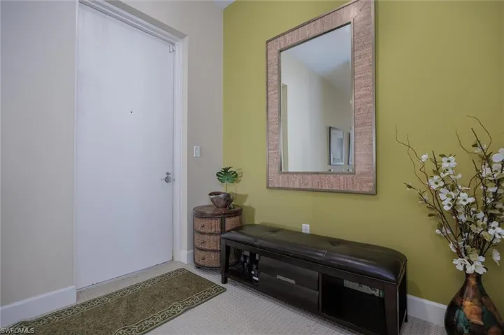 Entryway with baseboards and carpet