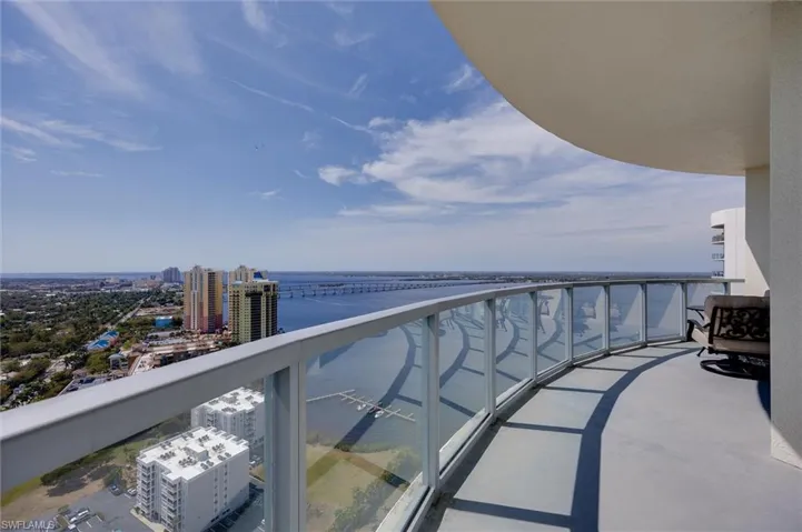 Balcony with a water view and a city view