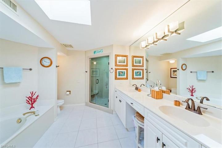 With large walk-in shower, tub and dual sinks
