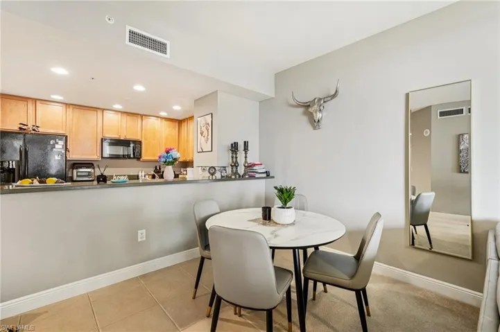 Dining room featuring light tile patterned floors and recessed lighting