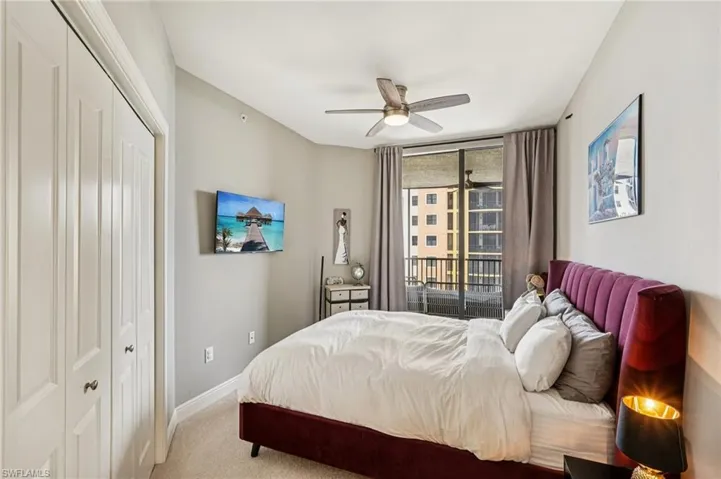 Bedroom featuring carpet floors, a closet, floor to ceiling windows, a ceiling fan, and access to outside