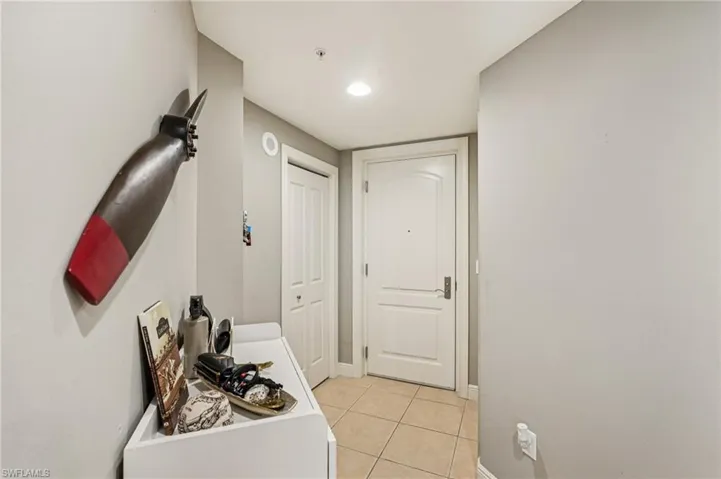 Hallway featuring light tile patterned floors and recessed lighting