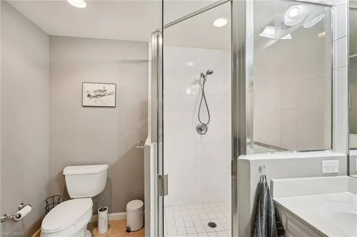 Full bathroom featuring vanity, a shower stall, recessed lighting, and light tile patterned floors