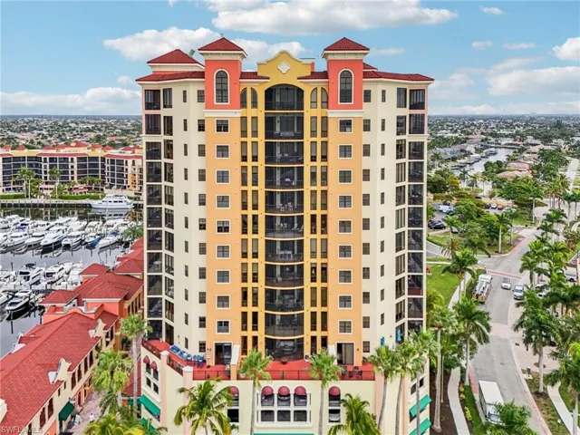 View of apartment building / complex with view of marina and a water view