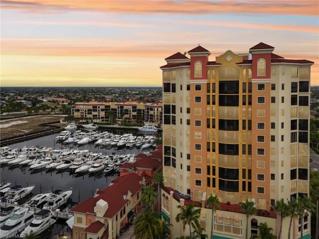 View of apartment building / complex featuring view of marina and a water view