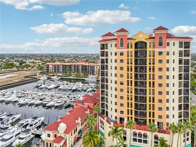 View of apartment building / complex featuring view of marina and a water view