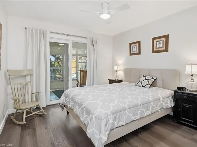 Bedroom with access to outside, dark wood-type flooring, and ceiling fan