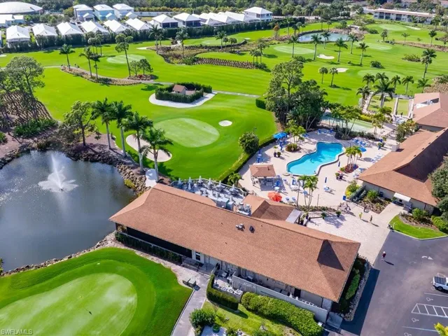 Aerial perspective of suburban area with a nearby body of water and a golf club