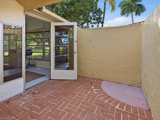 Doorway to property featuring a patio area and stucco siding