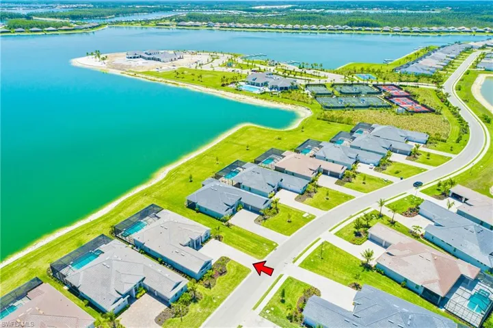 Aerial view of residential area featuring a nearby body of water