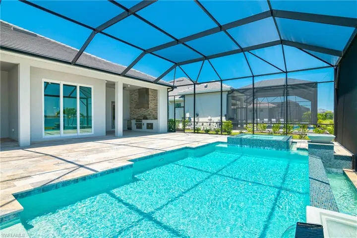 Integrated pool / spa featuring a sunroom, a patio area, and glass enclosure
