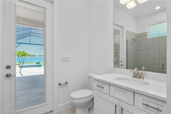 Full bath featuring vanity and a shower stall