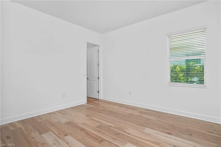 Spare room with light wood-style floors and baseboards