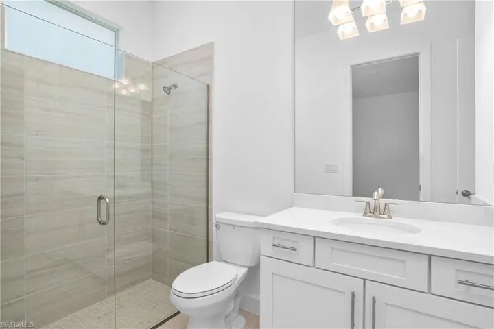 Bathroom featuring a shower stall and vanity