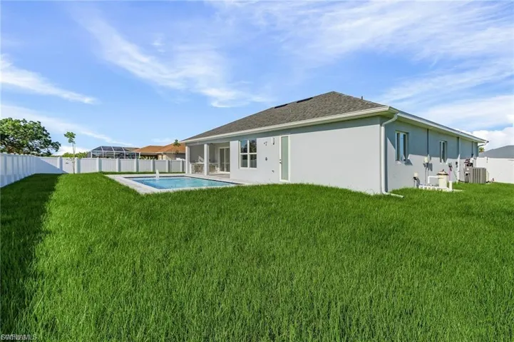 Rear view of property with a fenced backyard, a patio, a sunroom, and stucco siding